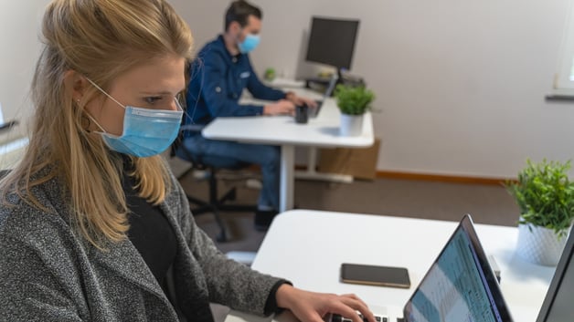 Workers with face masks in office